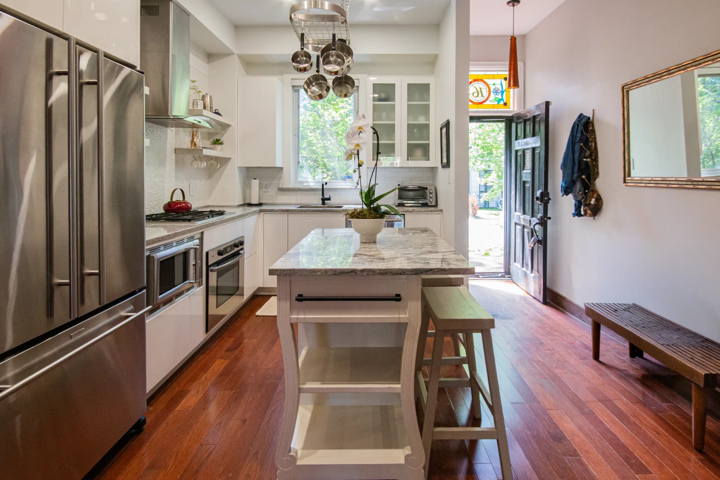 Kitchen detail with white cabinetry and stained-glass transom