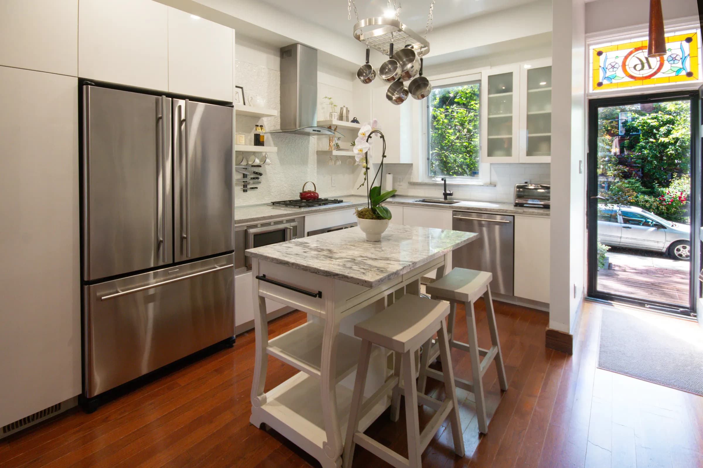 Bright modern kitchen with stainless appliances and a stone-top island